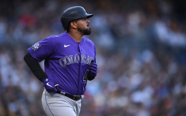 Colorado Rockies Player Running in Purple Jersey During Baseball Game Wallpaper