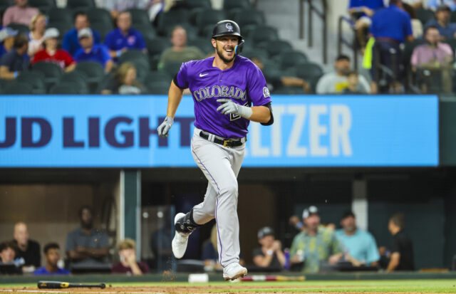 Colorado Rockies Player Running in Purple Jersey During Game Action Wallpaper