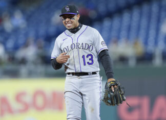 Colorado Rockies Player Wearing Number 13 on Field with Glove Baseball Wallpaper