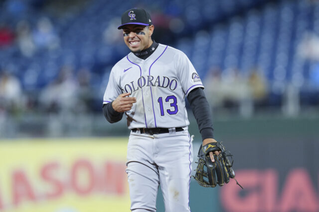 Colorado Rockies Player Wearing Number 13 on Field with Glove Baseball Wallpaper