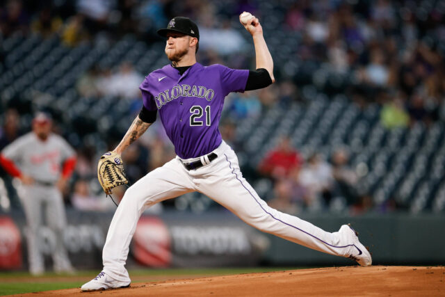 Colorado Rockies pitcher delivering a powerful throw in a professional baseball game wallpaper