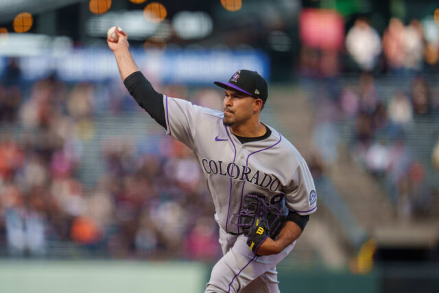 Colorado Rockies pitcher delivering a strong throw during a live game action wallpaper