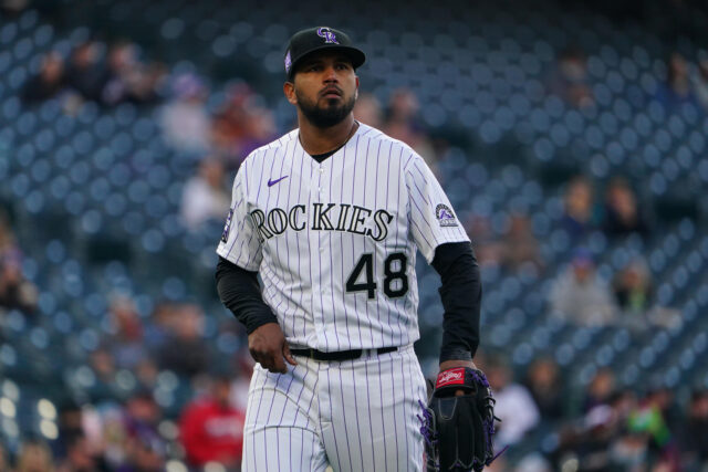 Colorado Rockies player in full uniform on the field during game moment wallpaper