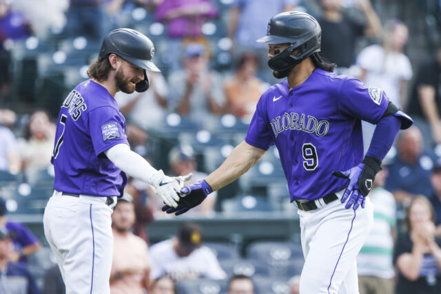 Colorado Rockies players celebrating during a baseball game action wallpaper