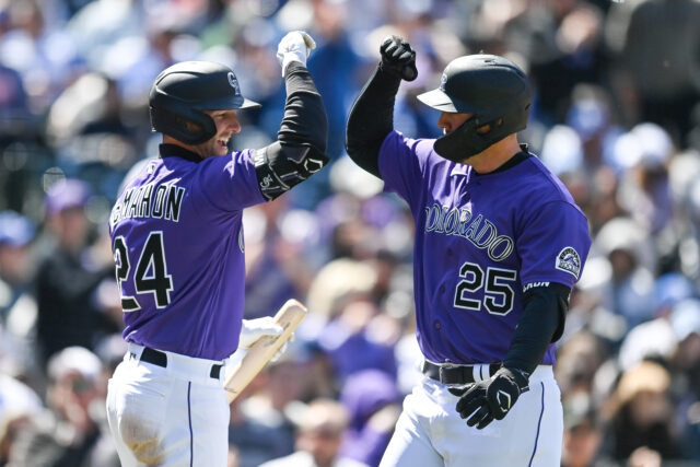Colorado Rockies players celebrating during baseball game in purple jerseys wallpaper