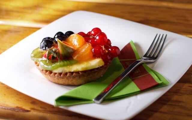 Colorful Fresh Fruit Tart on White Plate with Fork and Napkin Tart Wallpapers
