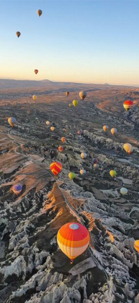 The Cappadocia wallpapers capture hot air balloons gliding over uniquely shaped rock formations, HD Phone Wallpaper