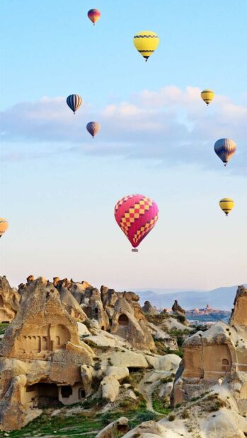 Several colorful hot air balloons are flying over the unique rock formations in Cappadocia, Cappadocia Wallpapers, HD Mobile Wallpaper