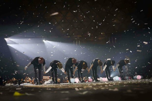 The artists are bowing on stage at the end of a concert surrounded by confetti and audience lights, HD Desktop Wallpaper