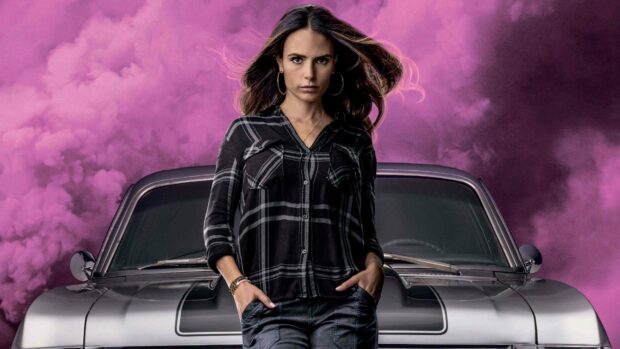 Jordana Brewster stands in front of a vintage car with purple smoke behind her, 4K Desktop Wallpaper
