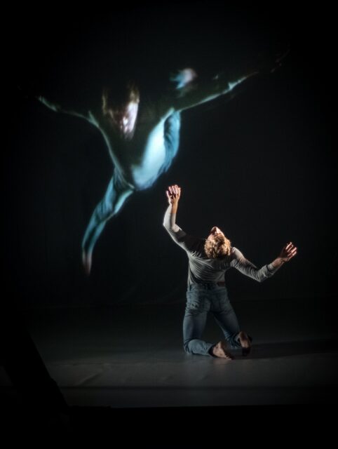 Contemporary Dance Wallpaper Male Dancer in Expressive Movement with Dynamic Shadow Projection