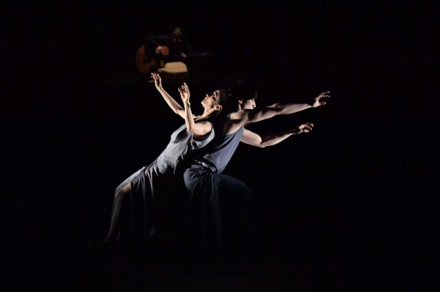 Contemporary dance wallpapers featuring expressive duet performance in dramatic lighting