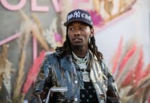 Cool Offset Rapper Wallpaper in Stylish Jacket and Cap with Chains Background