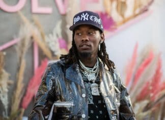Cool Offset Rapper Wallpaper in Stylish Jacket and Cap with Chains Background