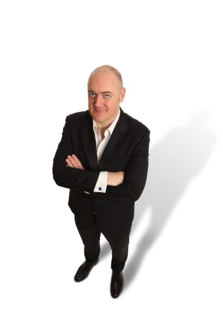 Dara O Briain In Black Suit Looking Upwards Wallpaper