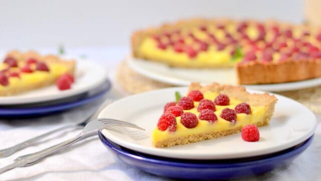 Delicious Raspberry Tart on Plate with Creamy Filling Tart Wallpapers Background