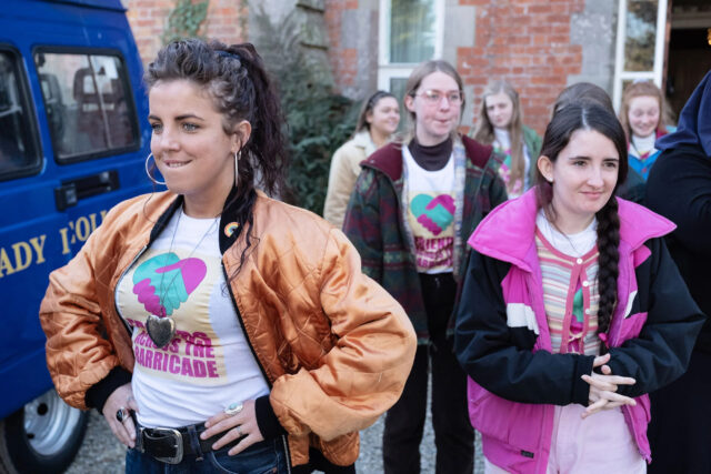Derry Girls TV Series Girls Wearing Vintage Jackets and T Shirts Outdoors Wallpaper