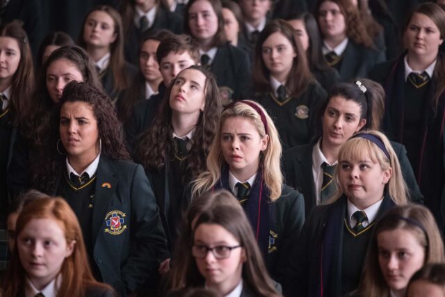 Derry Girls TV Series Group of Schoolgirls in Uniform Classroom Scene Wallpaper