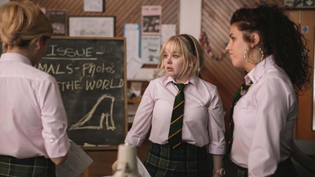 Derry Girls TV Series Wallpaper Characters in School Uniform Discussing in Classroom