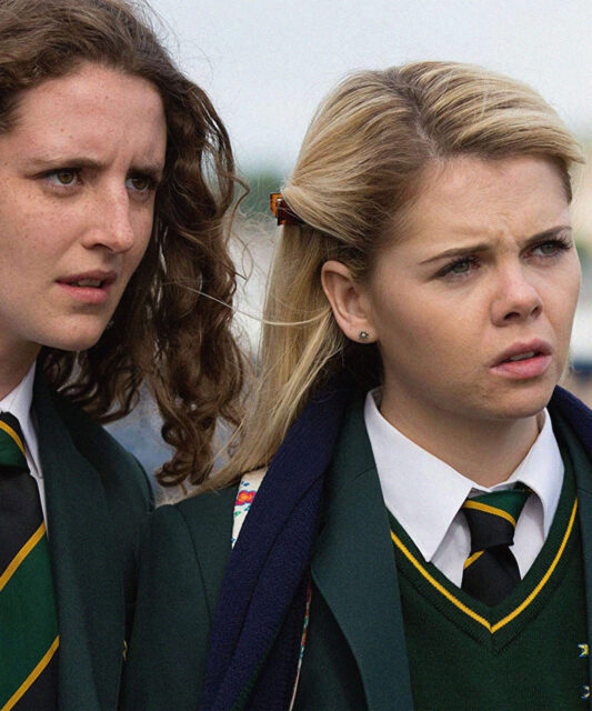Derry Girls TV Series Wallpaper Close Up of School Girls in Uniform Looking Concerned
