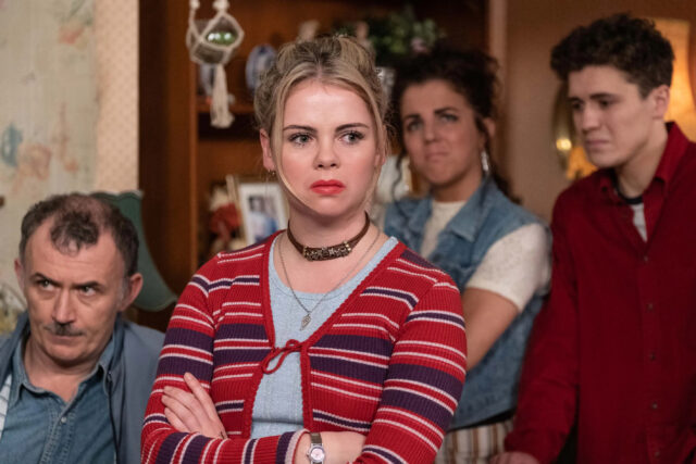 Derry Girls TV Series Wallpaper Featuring Main Characters in Intense Scene