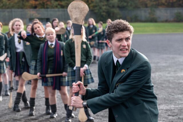 Derry Girls TV Series Wallpaper School Hurling Match with Students in Uniform