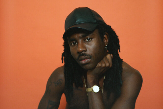 Dev Hynes Minimalist Portrait Wallpaper In Orange Tone