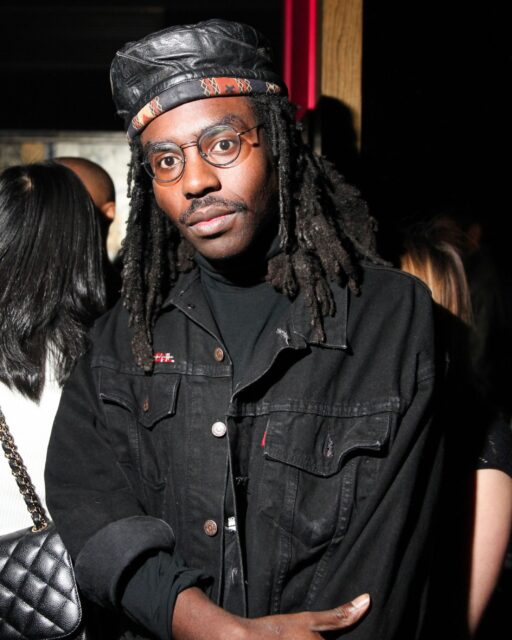 Dev Hynes Nighttime Style Black Jacket And Cap Look