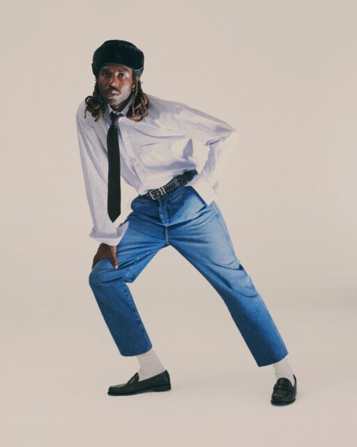 Dev Hynes Stylish Pose In Denim And Tie Outfit Wallpaper