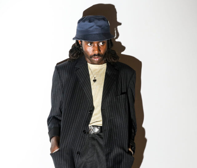 Dev Hynes Stylish Wallpaper In Pinstripe Suit And Hat