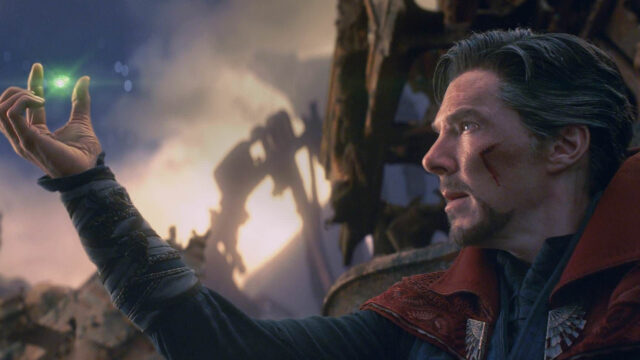 Doctor Strange holding a glowing magical artifact against a mystical background wallpaper