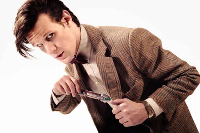 The image shows Matt Smith as Doctor Who holding a sonic screwdriver, HD Desktop Wallpaper