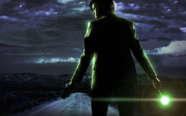 The Doctor stands on a dark road under a cloudy sky holding a glowing object in hand, HD Desktop Wallpaper