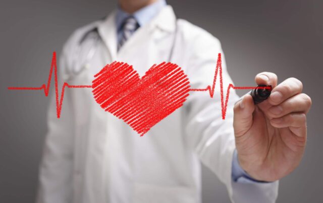 Doctors Hand Drawing Heartbeat Line Wallpaper