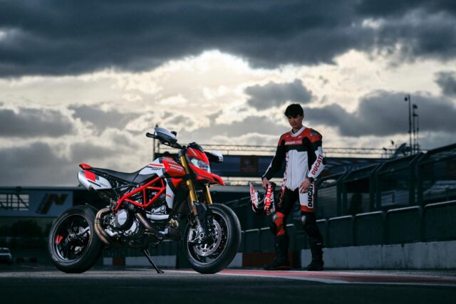 Ducati Hypermotard 950 Motorcycle and Rider on Race Track with Dramatic Sky Background Wallpapers