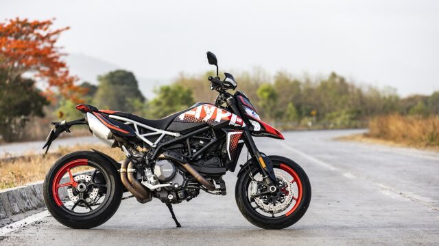 Ducati Hypermotard 950 Red and Black Motorcycle Parked on Open Road Wallpaper