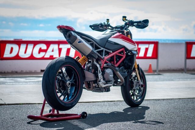 Ducati Hypermotard 950 Sporty Motorcycle Parked with Ducati Banner Background
