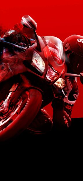 A rider leans into a sharp turn on a red Aprilia motorbike with glowing headlights, 2K Mobile Wallpaper