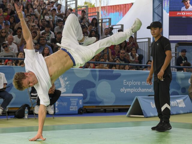 Dynamic Breakdancing Moves Captured In Action Wallpaper