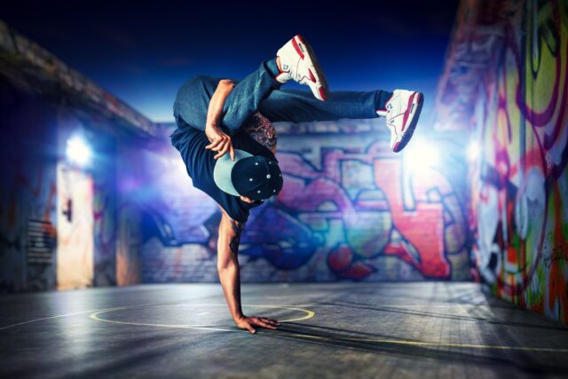Dynamic Breakdancing Moves In Urban Graffiti Setting