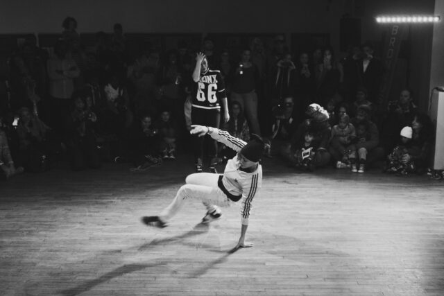 Dynamic Breakdancing Performance In Urban Dance Battle Scene
