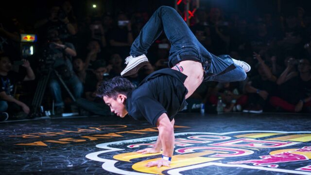 Dynamic Breakdancing Pose Captured In Action Wallpaper