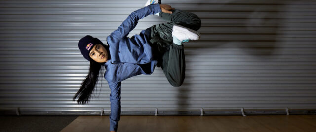 Dynamic Breakdancing Pose Captured In Motion Wallpaper