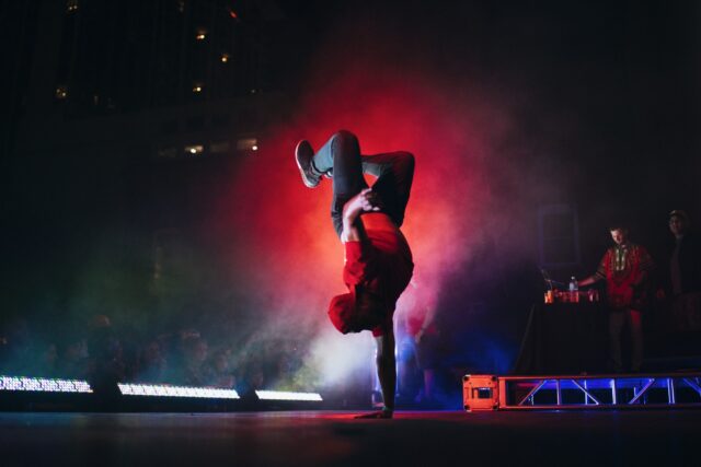Dynamic Breakdancing Pose Vibrant Street Dance Wallpaper