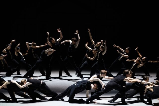 Dynamic Group Performance in Contemporary Dance Wallpapers with Black Costume and Dramatic Lighting