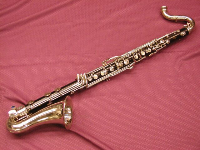 Elegant Bass Clarinet On Textured Red Background Wallpaper