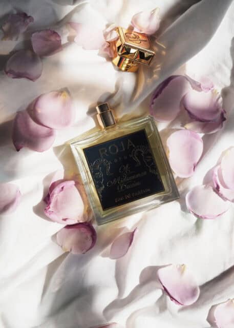 Elegant Roja Dove Perfume With Rose Petals Wallpaper