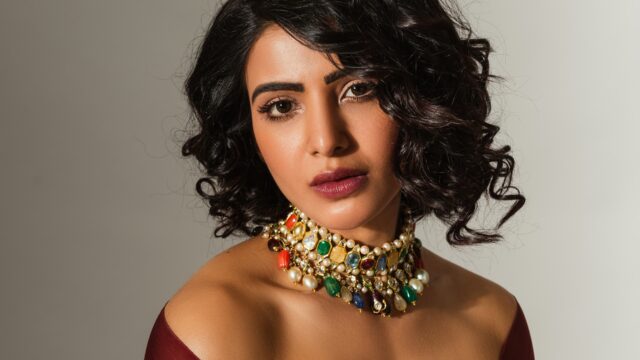 Elegant woman wearing vibrant gemstone choker perfect for stylish choker wallpapers