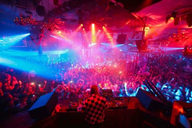 A DJ performs on stage with vibrant lights and a cheering audience at the concert, HD Desktop Wallpaper