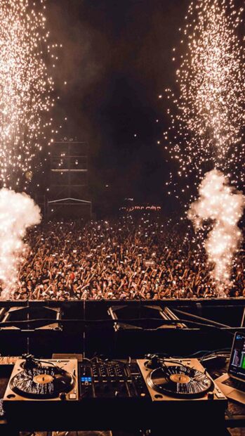 The concert scene shows a large crowd enjoying the live music with fireworks and DJ equipment in front, HD Phone Wallpaper